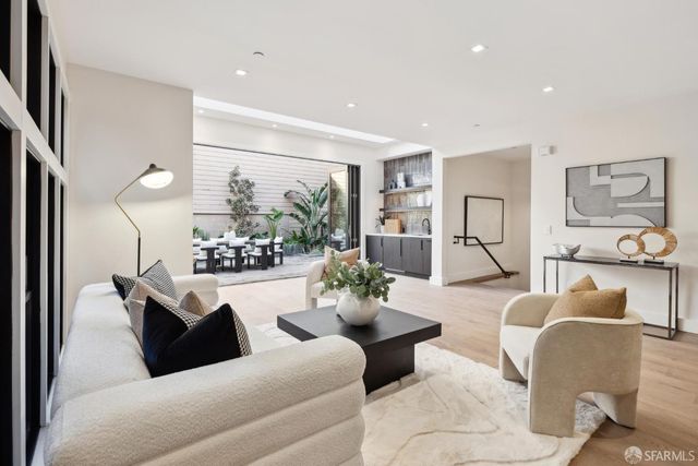 a living room with kitchen island furniture and a table