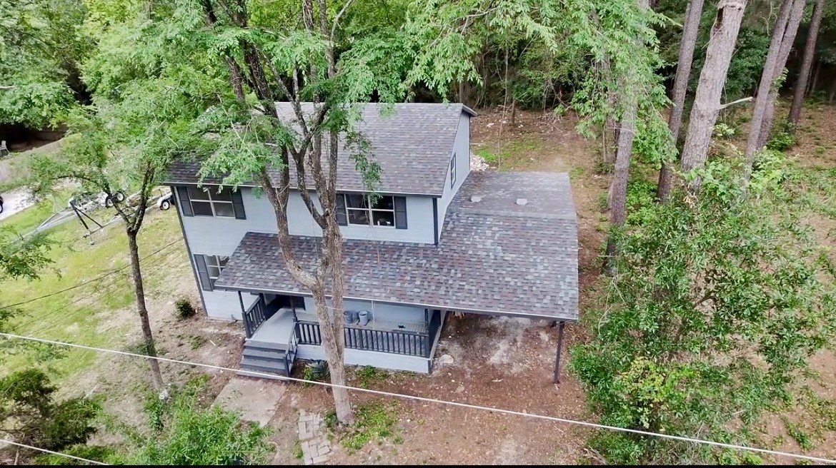 117 Amanda Street Conroe, TX 77304 - Photo 2 of 35 an aerial view of a house with a yard and large trees