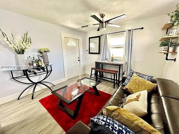 2425 Southwest 26th Terrace, Unit A Miami, FL 33133 - Photo 1 of 6 a living room with furniture and a window