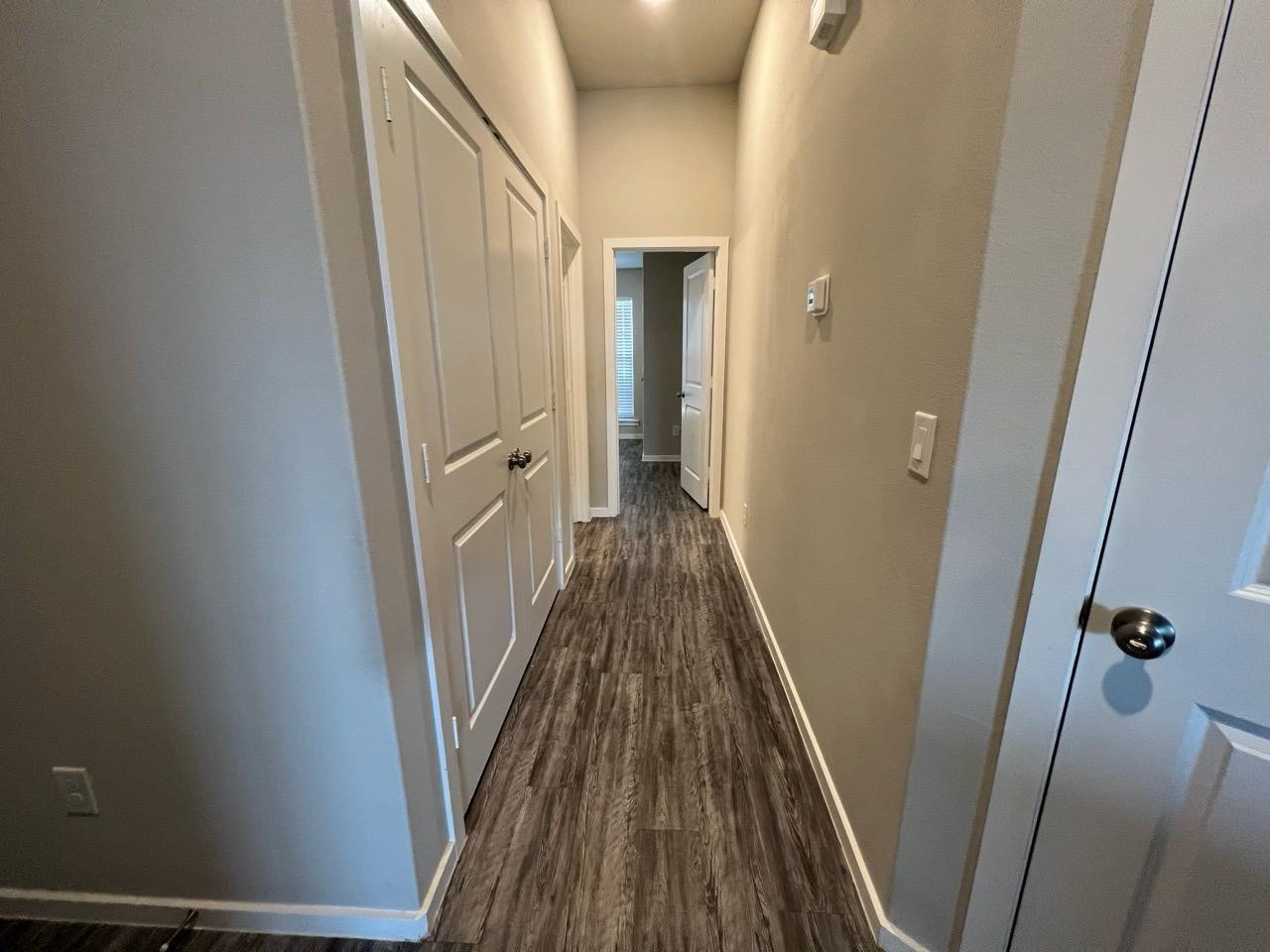 2121 North Avenue J, Unit A Lubbock, TX 79403 - Photo 8 of 20 a view of a hallway with wooden floor and staircase