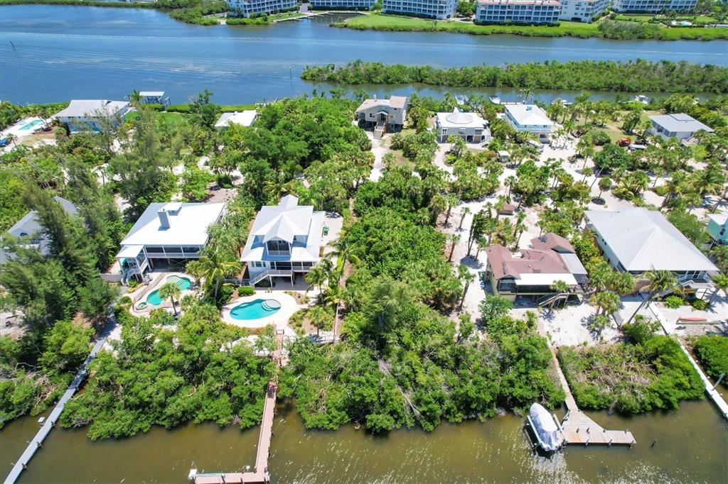 211 Kettle Harbor Drive Placida, FL 33946 - Photo 7 of 14 a aerial view of a house with a yard and lake view