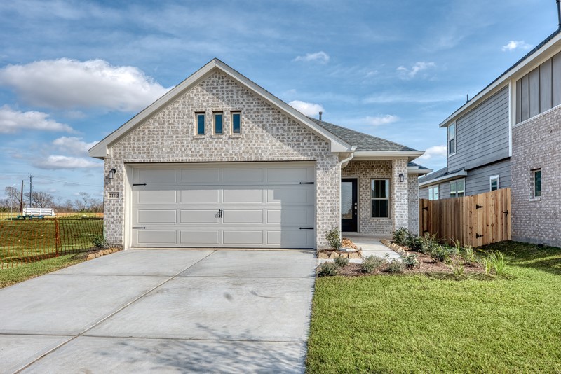 a front view of a house with a yard garage and outdoor seating