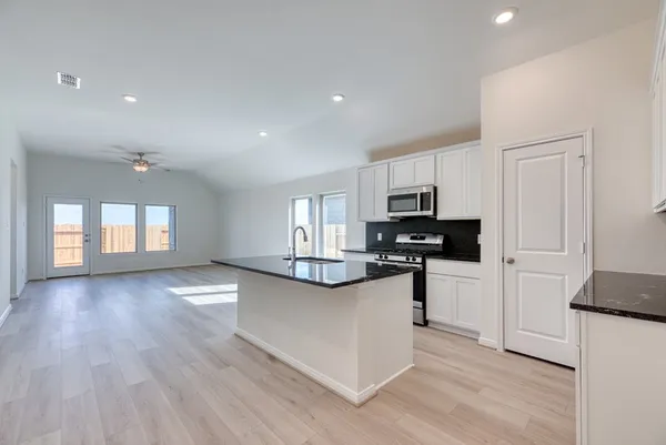 a view of kitchen with cabinets and wooden floor
