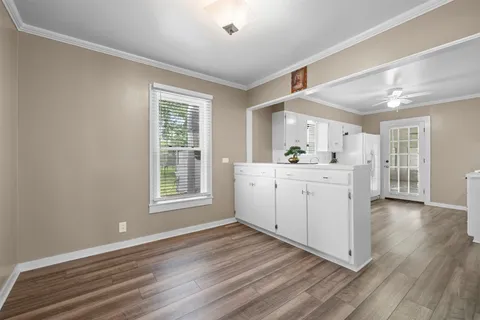 a kitchen with a sink cabinets and wooden floor