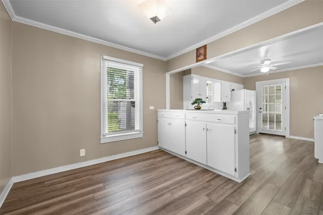 a kitchen with a sink cabinets and wooden floor