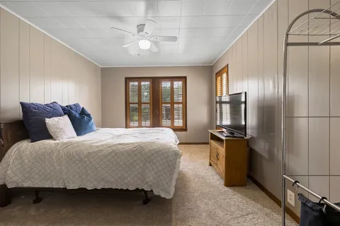a spacious bedroom with a bed and a chandelier