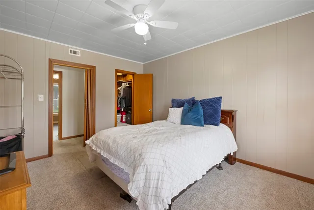 a bathroom with a sink a mirror and a potted plant