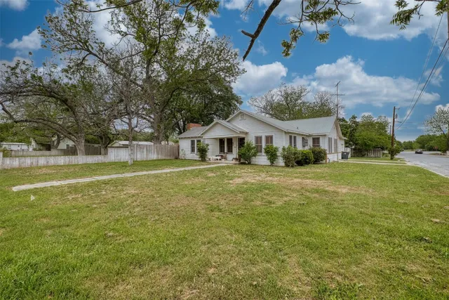a front view of house with yard and green space