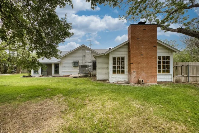 a view of a backyard with table and chairs and a fire pit