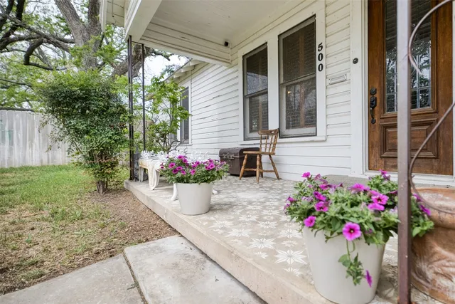 a flower garden in front of a house