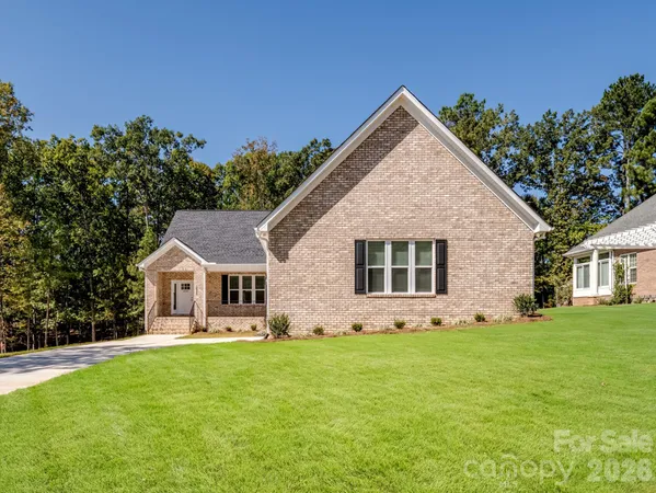 a front view of house with yard and green space