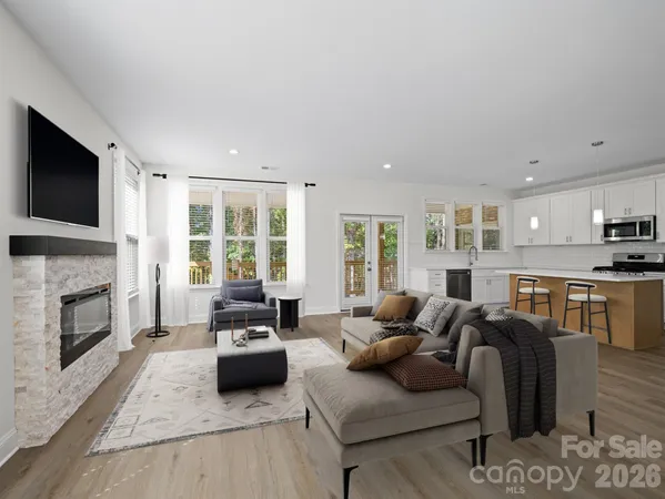 a living room with furniture fireplace and flat screen tv
