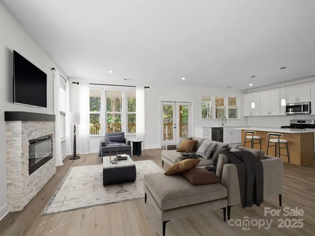 a living room with furniture fireplace and flat screen tv