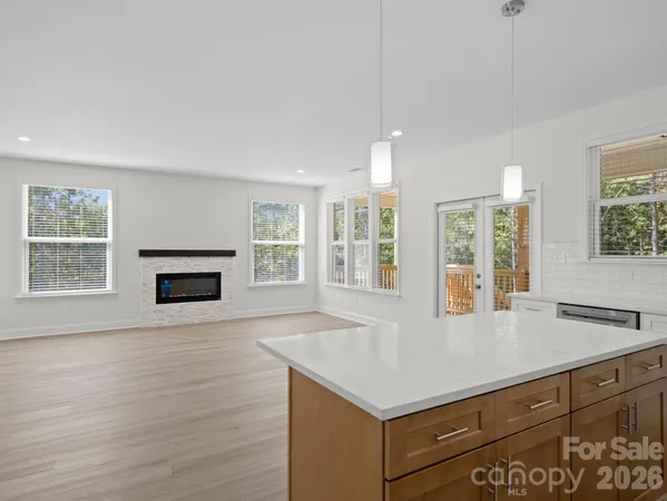 a view of kitchen with granite countertop window and a sink