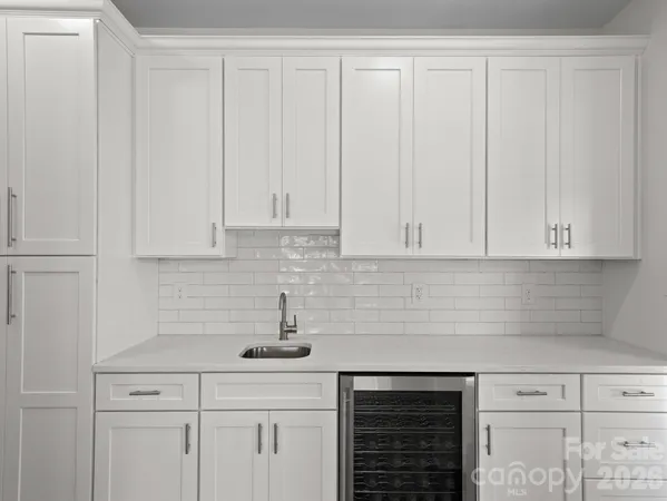 a kitchen with white cabinets and a sink