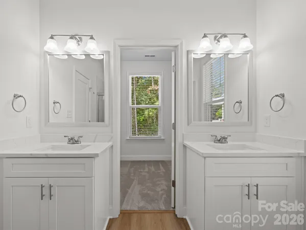 a bathroom with a sink vanity and a mirror
