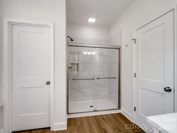 a bathroom with a glass shower door