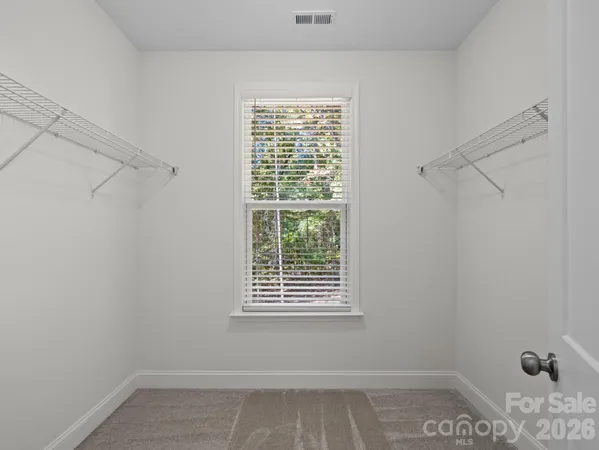 a view of a room with rack on the wall and a window