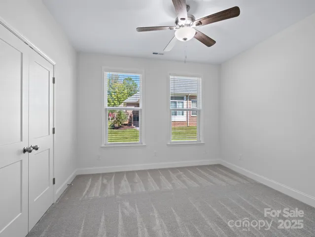 a view of room with a ceiling fan and window
