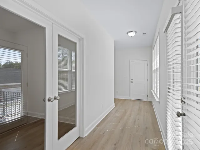 a view of a room with wooden floor and windows