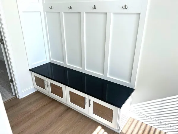 a kitchen with stainless steel appliances a white and white cabinets