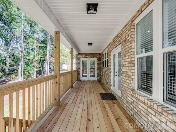 a view of balcony with wooden floor