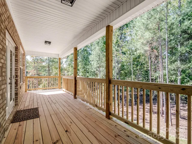 a view of a room with wooden floor and iron stairs
