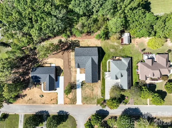 an aerial view of a house with a yard and lake view
