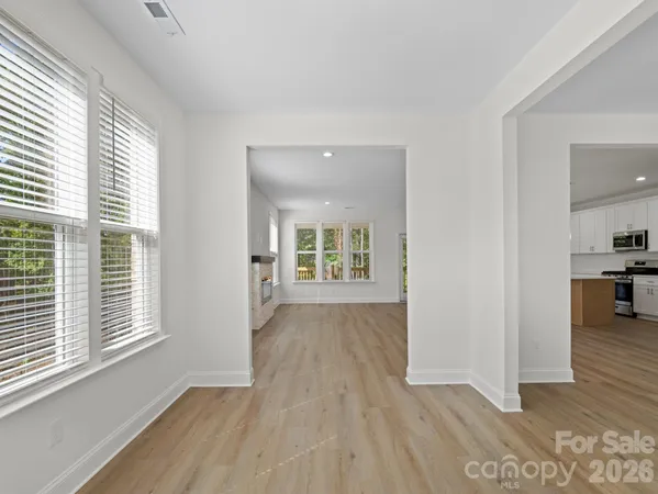 a view of a room with wooden floor and a window
