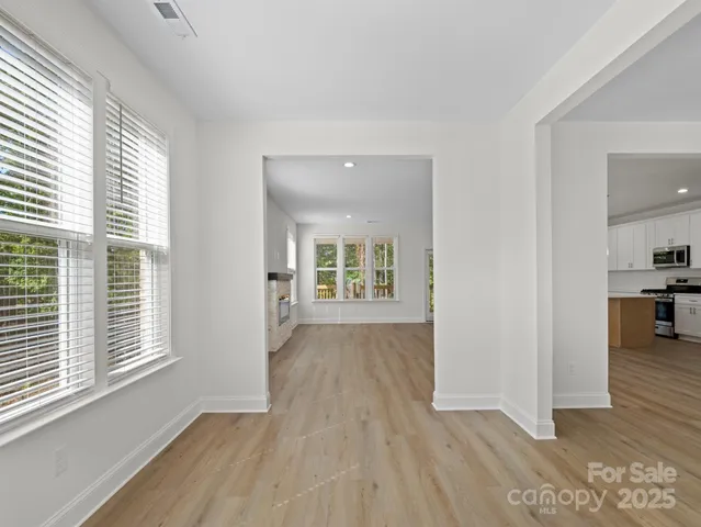 a view of a room with wooden floor and a window