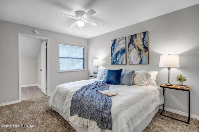 a bedroom with a bed and a painting on the wall