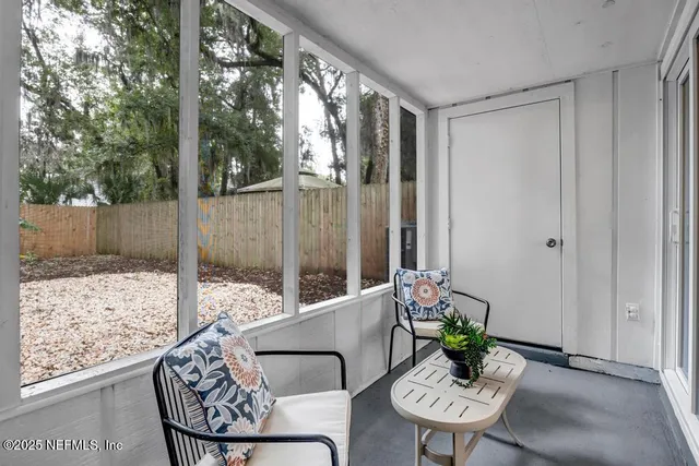 a view of a balcony with chairs and a table