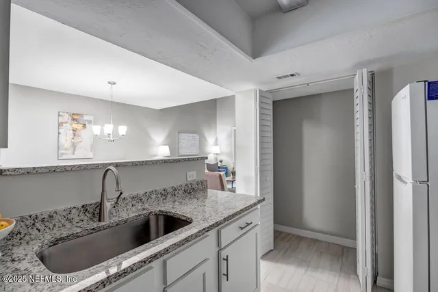 a kitchen with a sink and a refrigerator