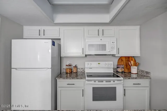a white refrigerator freezer sitting in a kitchen