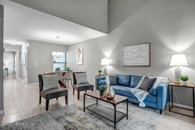 a living room with furniture and a lamp