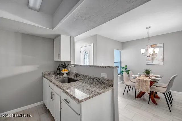 a kitchen with a table and chairs in it