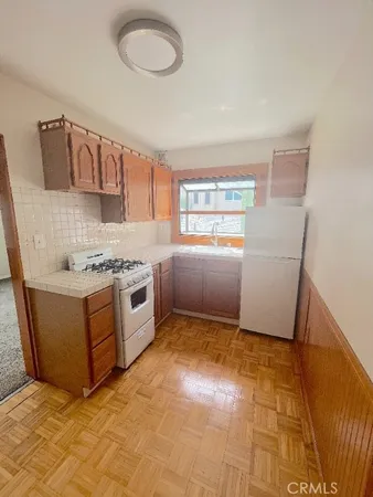 an empty room with a ceiling fan and windows