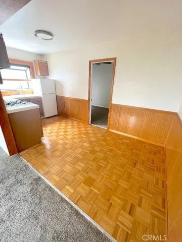 a kitchen with a stove a refrigerator and a cabinets