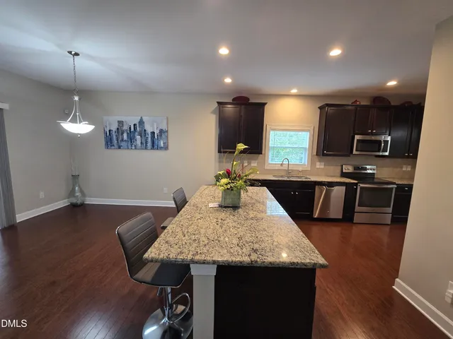 a kitchen with sink table and chairs