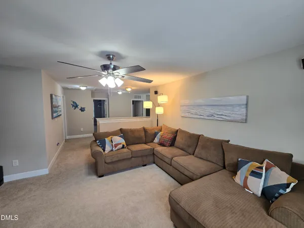 a living room with furniture and a chandelier