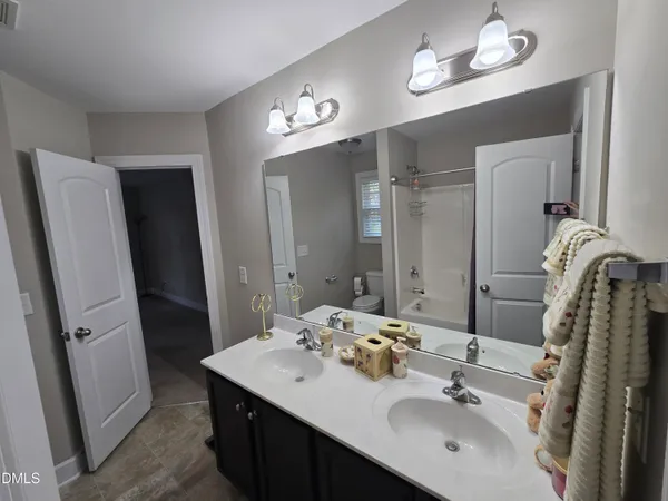 a bathroom with a sink double vanity and a mirror
