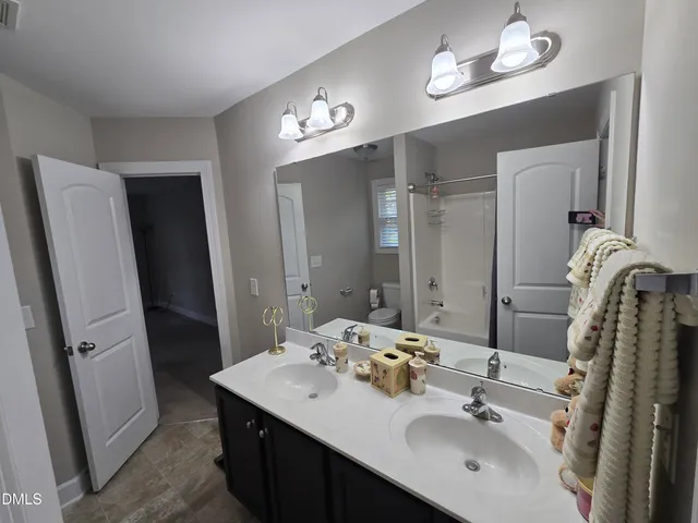 a bathroom with a sink double vanity and a mirror
