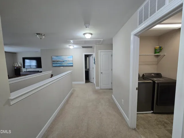 a view of a hallway with bathroom