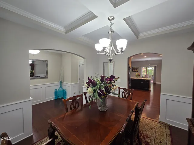 a view of a dining room with furniture and chandelier