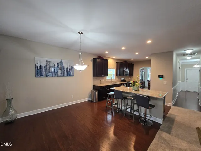 a view of a dining room with furniture wooden floor and chandelier