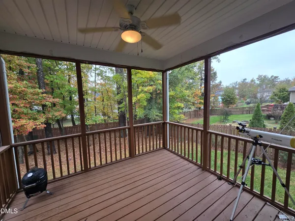 a view of balcony with wooden floor & fence