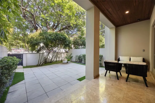 a view of a patio with table and chairs and potted plants