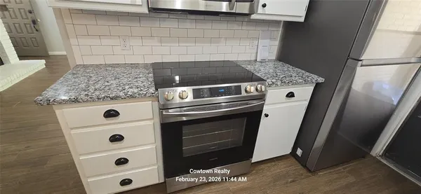 a stove top oven sitting inside of a kitchen