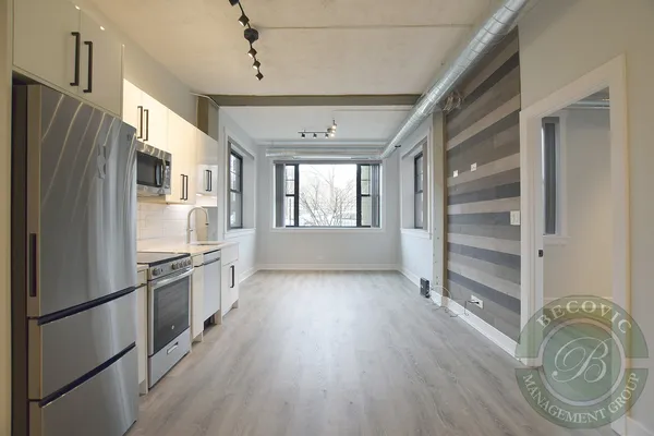 a kitchen with granite countertop stainless steel appliances a counter top space and cabinets