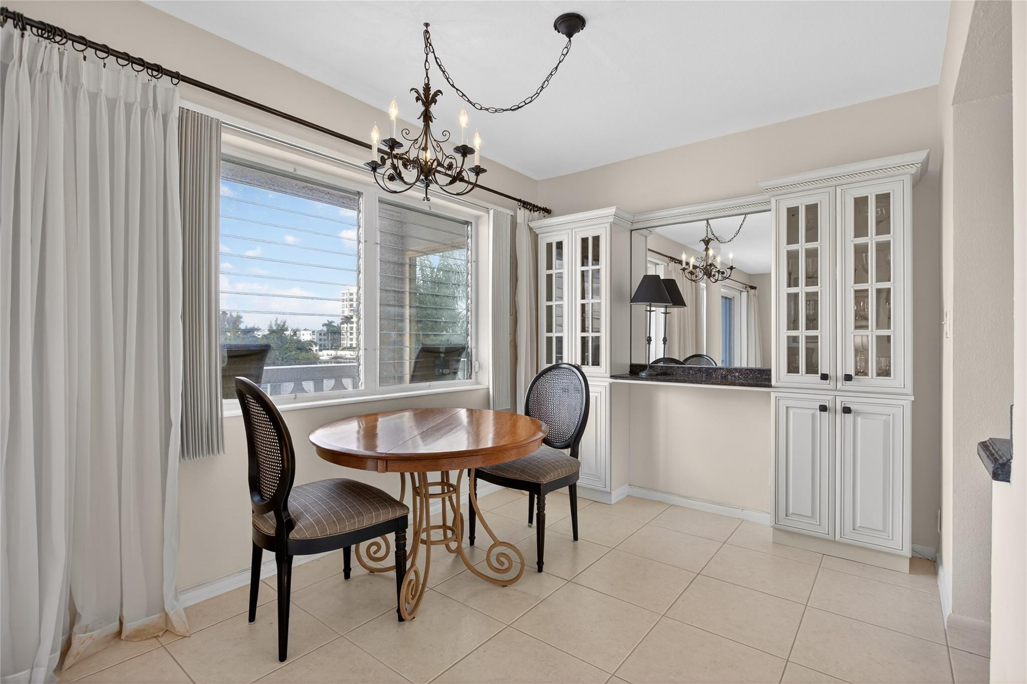 1001 North Riverside Drive, Unit 305 Pompano Beach, FL 33062 - Photo 14 of 44 a dining room with furniture a chandelier and window